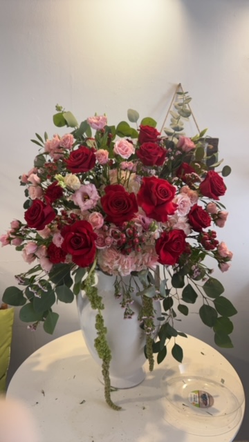 Red and pink roses with green leaves hanging