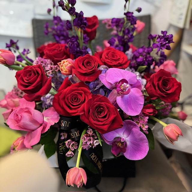 Red and pink roses with purple flowers