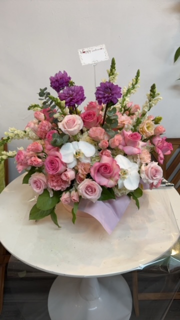 Arrangement with purple and pink roses