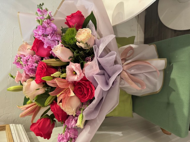 White bouquet with red roses, lilies, and white roses