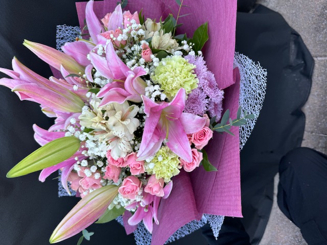 Pink bouquet with lilies, baby breath, and pink roses