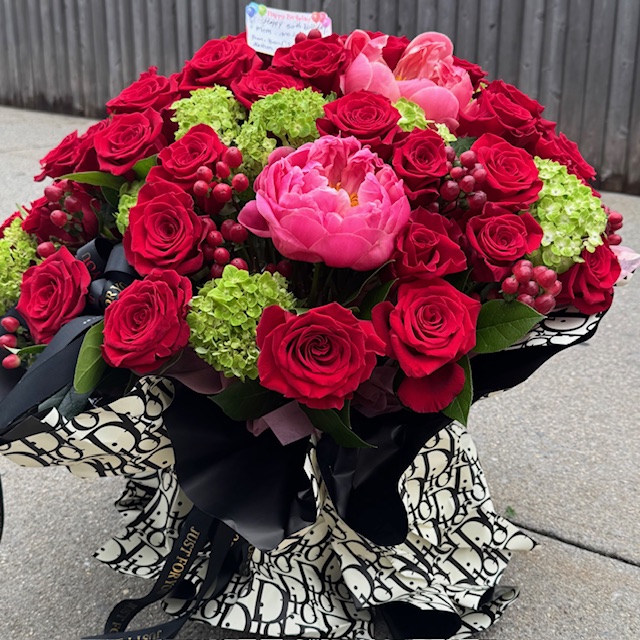 Black bouquet with red roses and green flowers