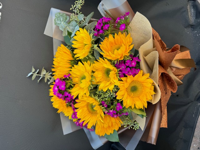 Orange bouquet with yellow and pink flowers